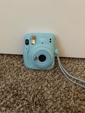 fujifilm instax mini 11 instant camera with an extra pack of film
